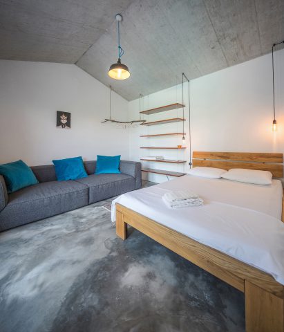 modern bedroom with concrete ceiling in garden studio