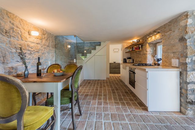 stone kitchen in traditional Istrian stone house with dining area